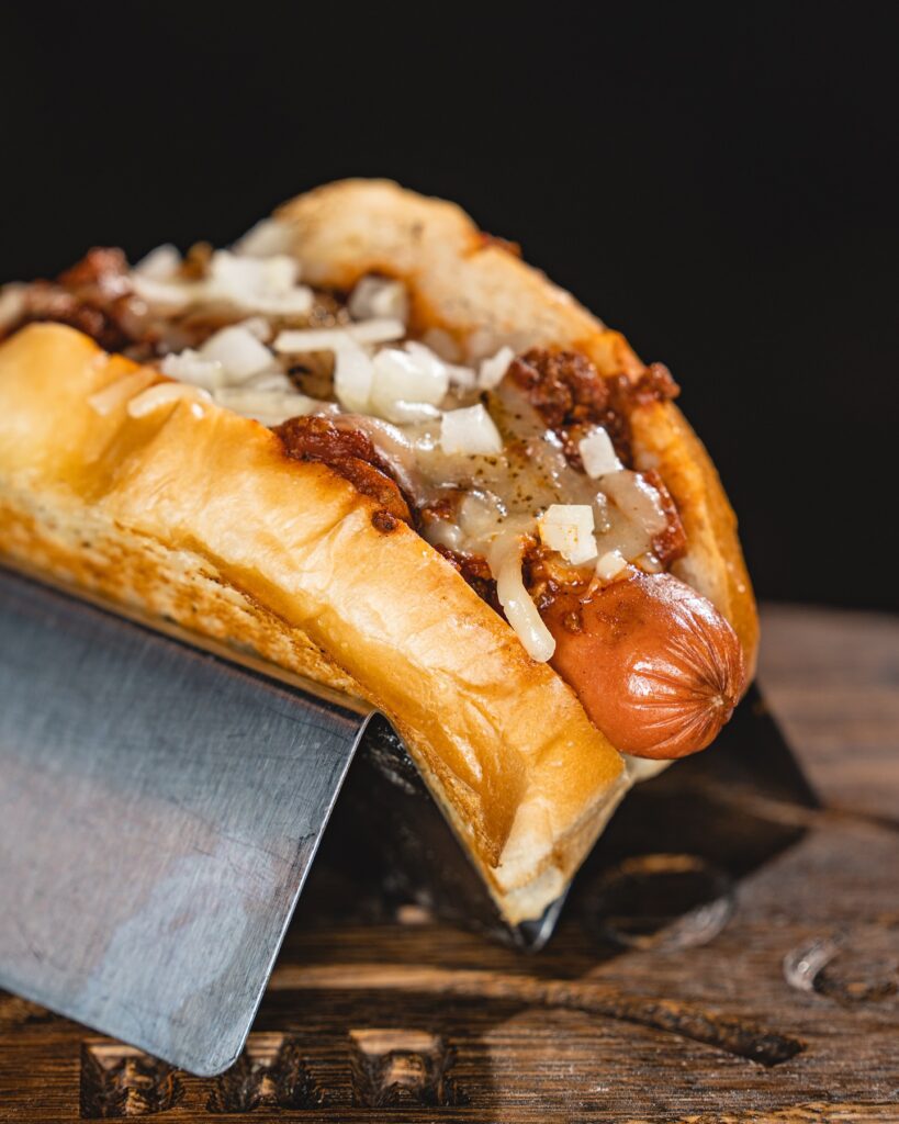 A Boonedogs chili dog topped with onions
